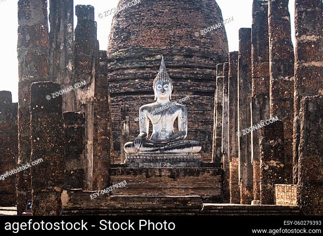 Horizontal photo of a beautiful and ancient Buddha in the ruins of the Wat Sa Si temple, in Sukhothai Historical Park. In Sukhothai, Thailand