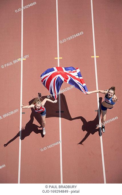 Runners celebrating on track with American flag
