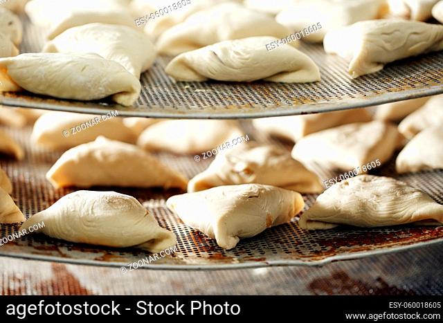 billet bun of dough with filling inside. Prepared for baking in baking production. manufacturing of food products. Baker lays out the workpiece