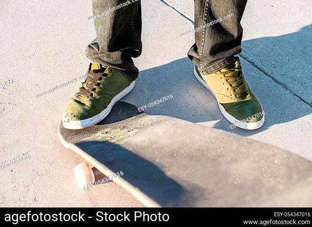 Close-up of skateboarder foot while skating in skate park