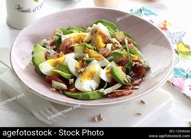 Egg salad with avocado and bacon, pumpkin seeds and blue cheese