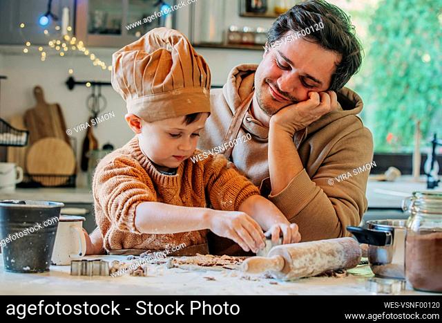 Father with son preparing cookies at home