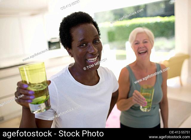 Portrait confident senior women friends drinking water after workout
