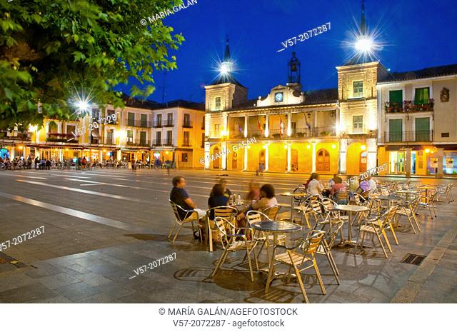 People sitting on terraces at Main Square, night view. El Burgo de Osma, Soria province, Castilla Leon, Spain
