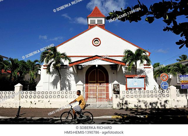 France, French West Indies, Saint Martin island, Marigot, man on a bicycle passing in front of the Methodist Church