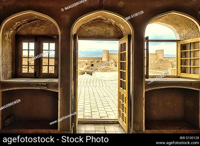 Ruins, towers and walls of the Rayen Citadel viewed through a window, Biggest adobe building in the world, Kerman Province, Iran, Asia