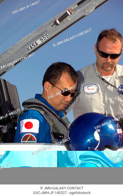 Astronaut Soichi Noguchi, STS-114 mission specialist, goes through a pre-flight check of the systems of a NASA T-38 trainer jet prior to a flight to Kennedy...