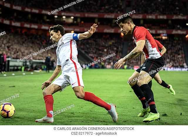 Jesus Navas (L) and Yuri Berchiche (R) dispute the ball during a Spanish League match between Athletic Club Bilbao and Sevilla FC at San Mames Stadium on...