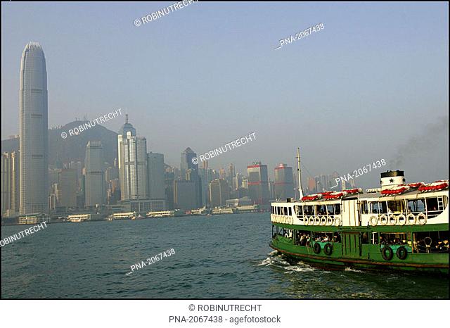 The Star ferry between Kowloon and Hong Kong  On the left side the tallest building in Hong Kong the 2IFC