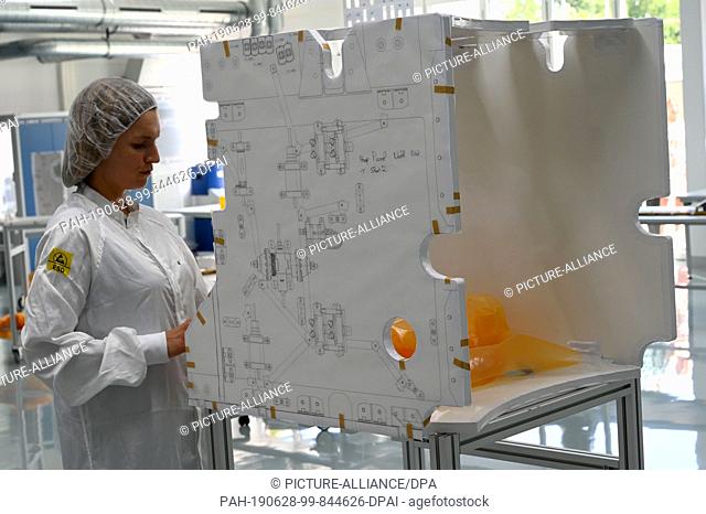 28 June 2019, Bremen: An employee of the OHB space group is standing in the ""Mikroba"" clean room. The new room was put into operation as a ""Transparent...