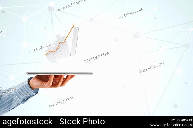Businessman hand holding tablet with finance graph on screen