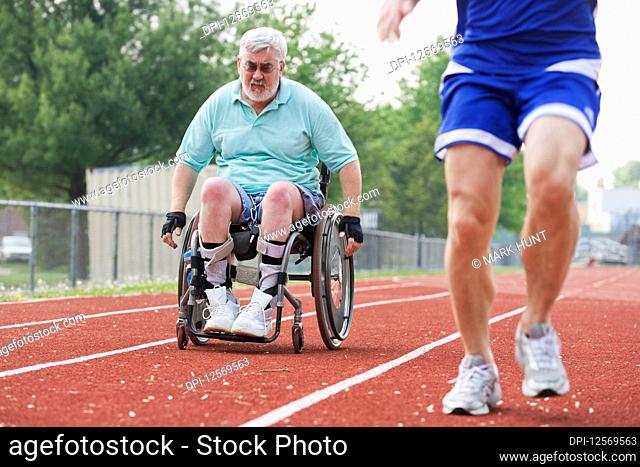 View of a handicapped senior man racing with a young man