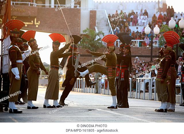 Indian border security force soldiers and Pakistani  counterpart doing parade before start changing of guard ceremony at Wagah border ;  Amritsar ; Punjab ;...