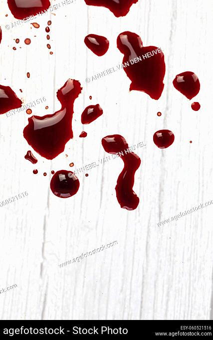 blood stains on white wooden background, dripped and splatterd blood with copy space, injury wound, concept space for text