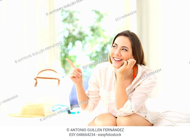 Hotel guest pointing at side in a room on summer vacations on the beach