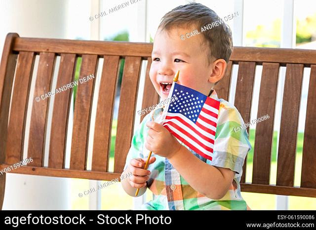 Young Mixed Race Chinese and Caucasian Boy Playing With American Flag