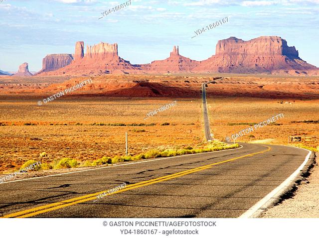 One of the most famous images of the Monument Valley is the long straight road US 163leading across flat desert towards sandstone buttes and pinnacles rock...