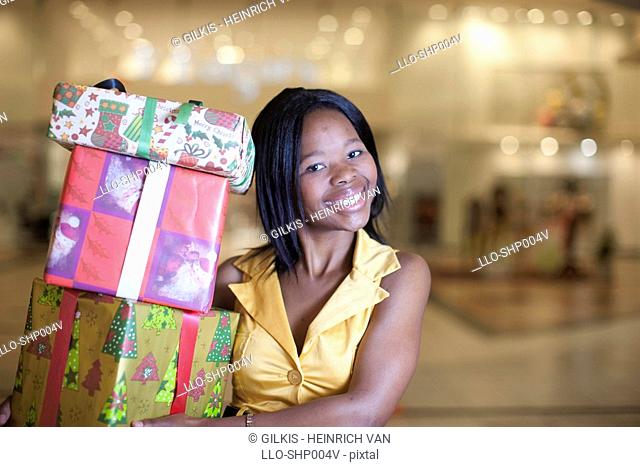 Woman holding Christmas gifts, KwaZulu Natal Province, South Africa