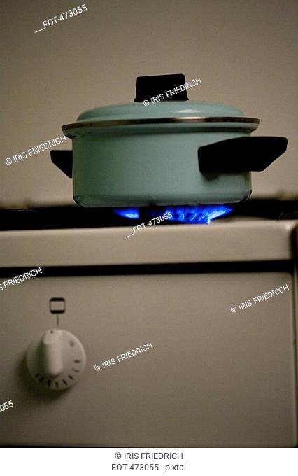 A saucepan on a lit stove