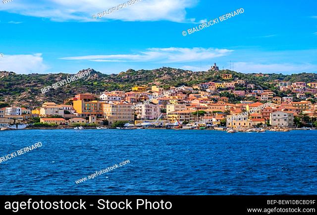 La Maddalena, Sardinia / Italy - 2019/07/17: Panoramic view of La Maddalena old town quarter with port at the Tyrrhenian Sea coastline and island mountains...