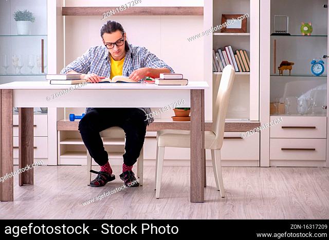 Male student preparing for exam at home