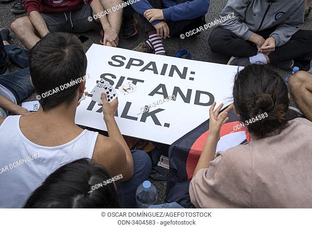 Barcelona, Spain. 21th Oct, 2019. Students play cards on a banner where you can read ""Sit and Talk"" during a protest in front of the Spanish Government...
