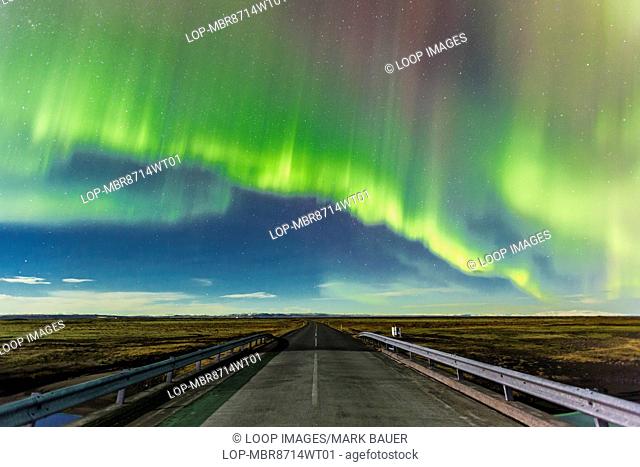 Aurora Borealis over a road near Vik in Southern Iceland