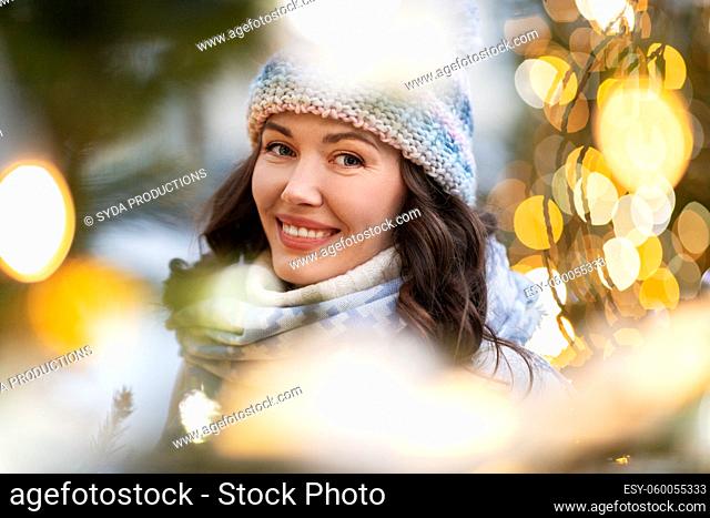 portrait of happy young woman in christmas lights