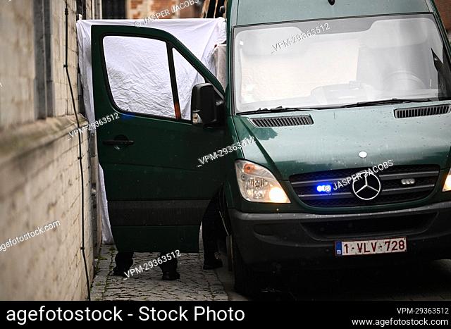 A van with an open door and white drapes is seen as the suspects arrive for a session of the council chamber at the justice palace in Mechelen