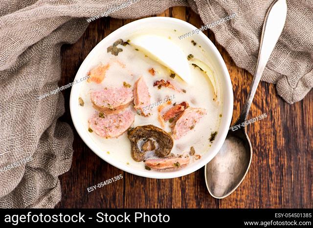 Traditional easter white borscht with eggs and sausage