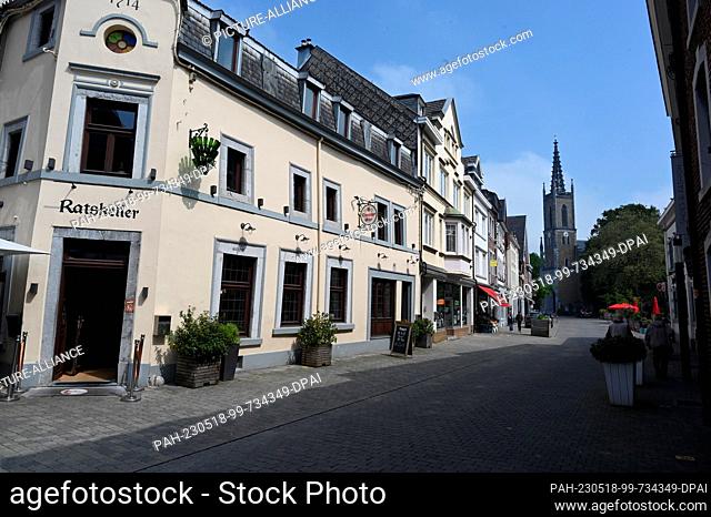 14 May 2023, Belgium, Eupen: Houses of the old town on the market square and the Protestant Peace Church in the upper town of Eupen