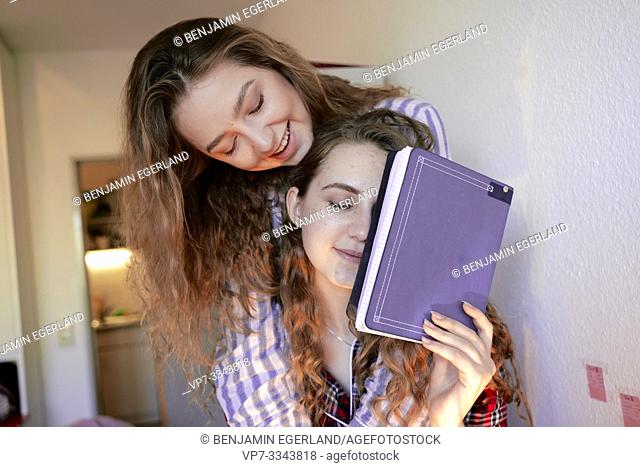 young tired women holding student notebook