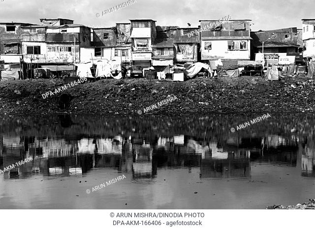 Bharat Nagar slum reflected in mithi river ; Bandra ; Bombay Mumbai ; Maharashtra ; India