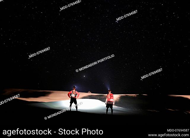 Ultramarathon Project. Two runners looking at the desert at night. Thar Desert (India), April 13th 2018