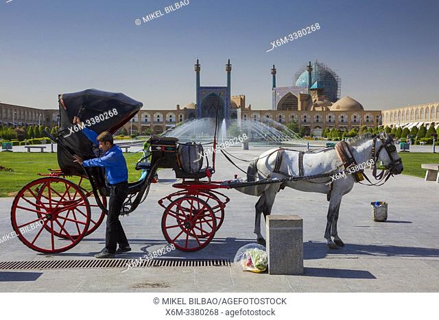 Tourist carriage and the Shah Mosque. Naghsh-e Jahan Square. Isfahan, Iran. Asia