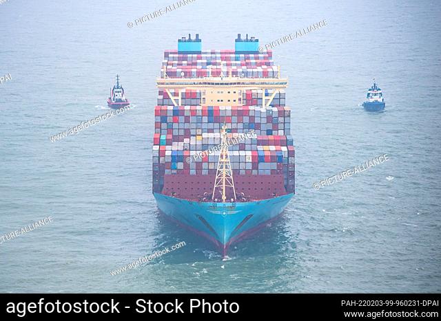 03 February 2022, Lower Saxony, Wangerooge: The ""Mumbai Maersk"" lies surrounded by tugs in the North Sea. The 400-meter container ship got stuck on Wednesday...
