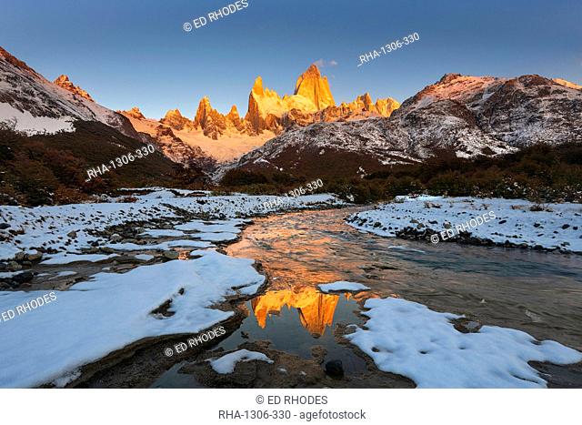 Mountain range with Cerro Fitz Roy at sunrise reflected in river, Los Glaciares National Park, UNESCO World Heritage Site, El Chalten, Patagonia, Argentina