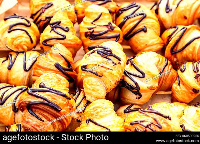 Freshly french baked croissants with chocolate. Food background
