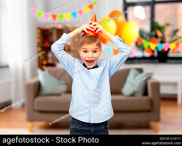 happy little boy in birthday party hat