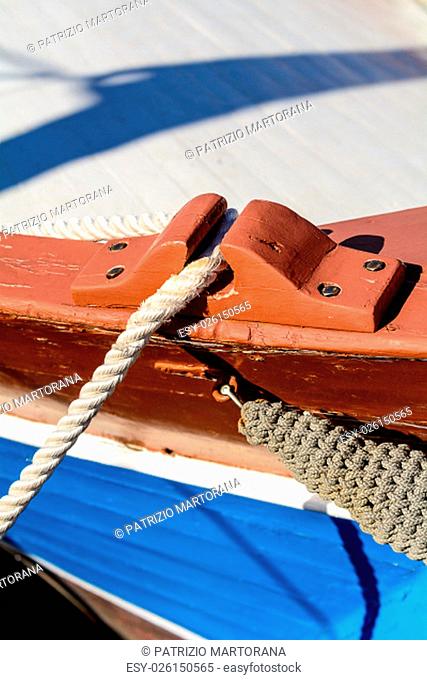 Fragmentary view details of knots and ropes on the yacht moored in the dock