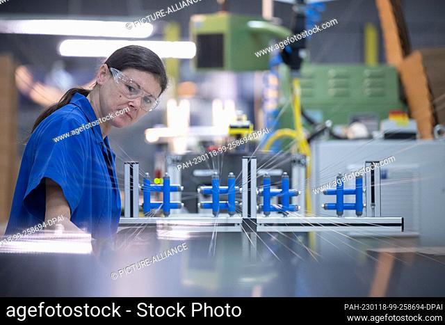 PRODUCTION - 12 January 2023, Rhineland-Palatinate, Mainz: A Schott AG employee works in the ""Lighting and Imaging"" department of the Schott AG glass...