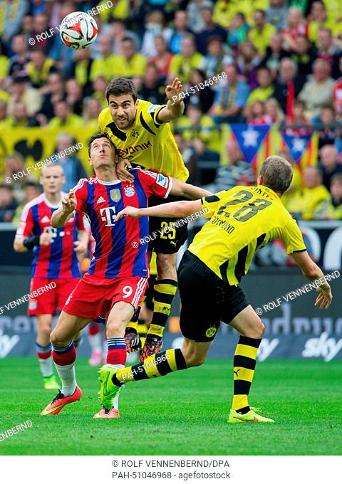 Dortmund's Sokratis (C) and Munich's Robert Lewandowski vie for the ball with Dortmund's Matthias Ginter (R) during the DFL Supercup soccer match Borussia...