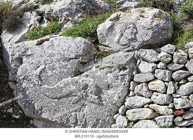 Sacred site of Artemidoros with a stone relief of a dolphin (Poseidon) and the head of Artemidoros, Thira, Santorini, Greece