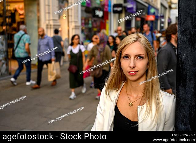 Attractive young urban girl standing out of the crowed in London, United Kingdom