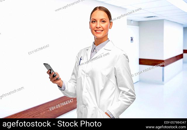 happy smiling female doctor with smartphone
