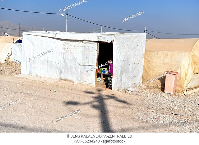 A girl stands in a tent where one can buy groceries in the Mamilian refugee camp in the Dohuk region, Iraq, 19 October 2016