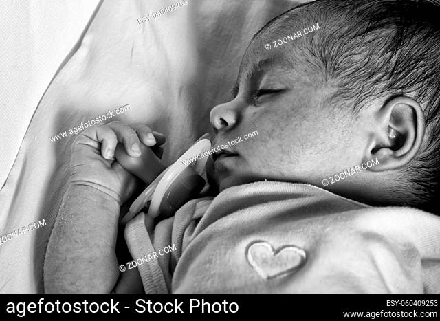 Newborn Baby Girl Sleeping in her Crib