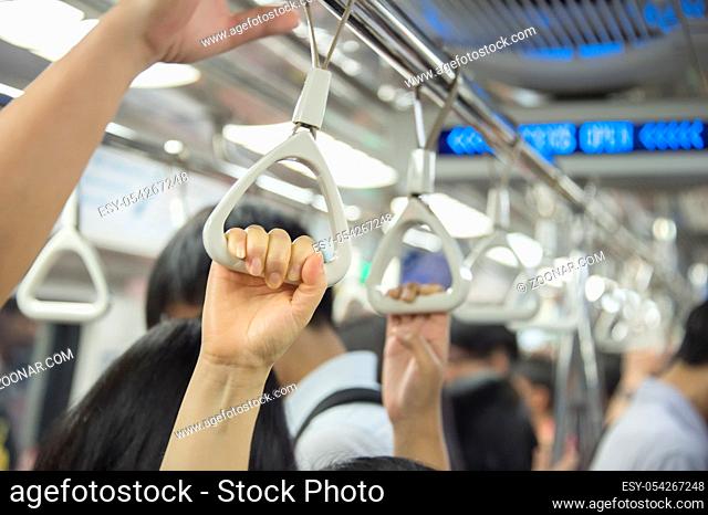 People inside the crowded metro train. Singapore