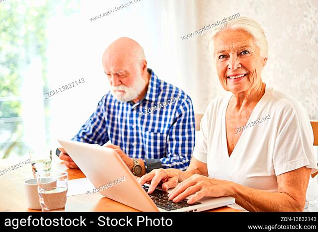 Senioren Paar mit Laptop Computer beim Surfen im Internet zuhause