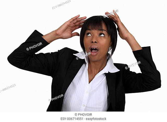 Scared businesswoman covering her head